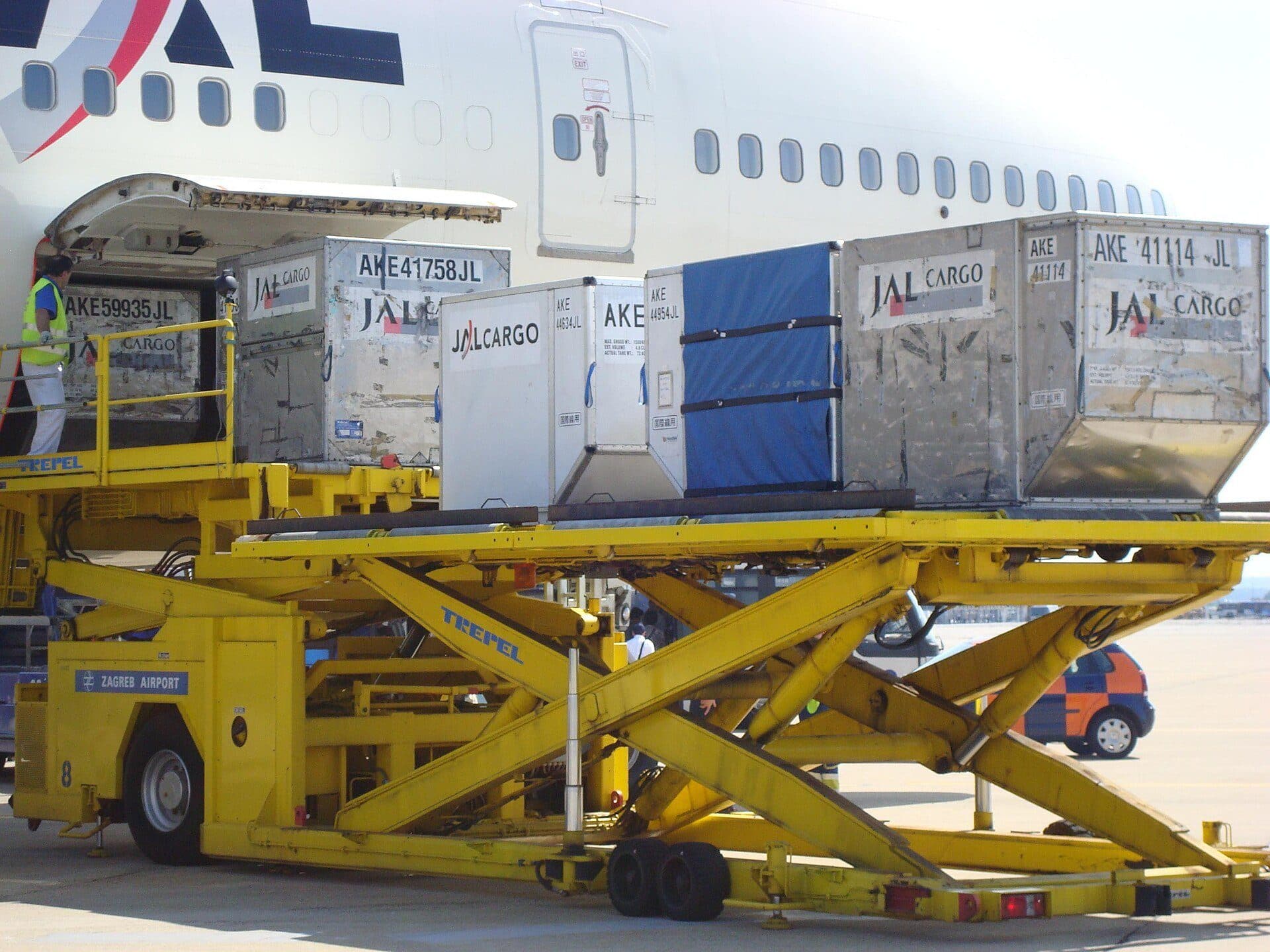 Air cargo containers being loaded into a freighter aircraft